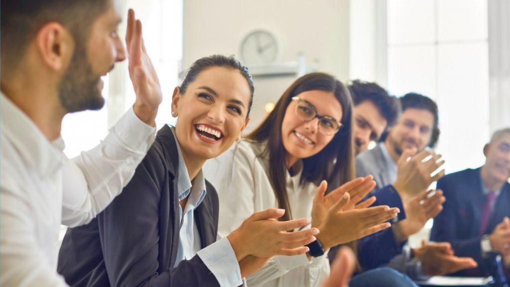 Group of people clapping for employee recognition